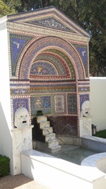 Outside Fountain with water plants and tiled wall